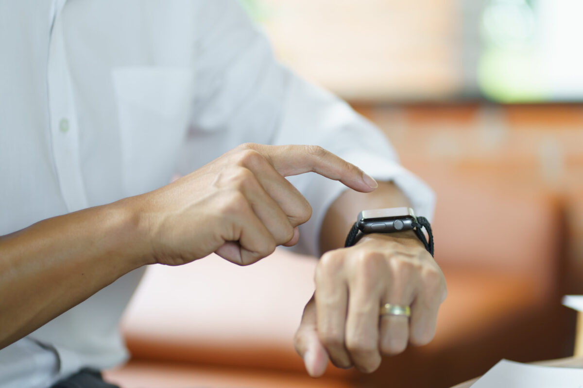 Business man Looking at smart watch In Office online connect Gadget technology.